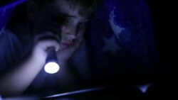 Reading hidden under covers Stock Footage