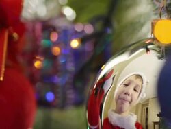 boy decorates a Christmas tree Stock Footage