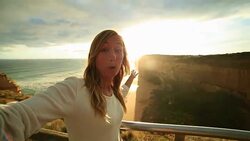 Caucasian female takes selfie portrait at the Twelve Apostles, Australia Stock Footage