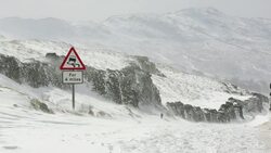 Massive snow drifts block the Kirkstone Pass road above Ambleside in the Lake District, UK during the extreme weather event of late March 2013. shot taken on 25th March 2013. Stock Footage