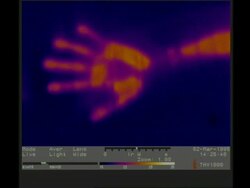 Thermographic image, CU hand moves out of frame, leaving thermal handprint Stock Footage
