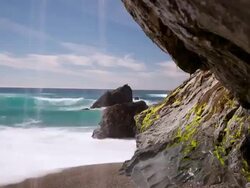 WS T/L Water spiling onto beach, rocks in front of ocean / Big Sur, California, United States Stock Footage
