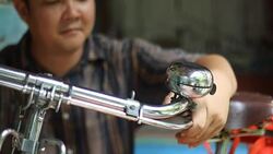 man repair bicycle bell Stock Footage