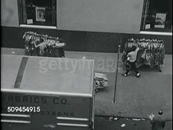1963: NEW YORK CITY GARMENT DISTRICT:  HA TD Men rolling garment racks of clothing on racks on sidewalk, men pushing carts filled w/ fabric rolls, bolts of cloth across street w/ pedestrian traffic.  Iconic, fashion, design, Chelsea neighborhood. Instructional Video