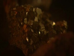 Lump of Bauxite lit by candle light, UK (sound available) Stock Footage