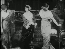 Helen Keller admires the millinery hats and Paris fashions upon a visit to New York City in 1910. News Clip