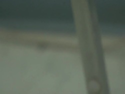 A United States Army sergeant's coat hangs on a chair near a pair of black military shoes. Stock Footage