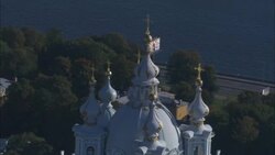 Domes and gold crosses adorn a blue and white church  in St. Petersburg, Russia. Stock Footage