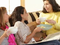 Hispanic friends chatting on couch together Stock Footage