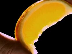 CU Lemon wedge holding by two finger pinch being squeezed and juice squirting out / Los Angeles, California, United States Stock Footage