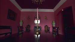 A candlestick centers a dining table in a pink dining room at La Maison Hotel in Rio de Janeiro. Stock Footage