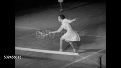 1950: CLIFTON TENNIS CLUB: NIGHT: Young adults walking toward clubhouse. VS Young woman in tennis skirt & male in shorts BG playing Doubles tennis game on court. Instructional Video
