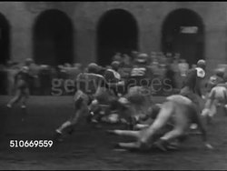 1951: HARVARD UNIVERSITY INTRAMURAL SPORTS: CU Handwritten sign 'Kirkland vs Eliot House Football Wed 2pm...' VS Non-varsity football game w/ officials, players in uniforms, VS Student fans standing sidelines, MS Straus Cup trophy.  (Kirkland 1951) Instructional Video
