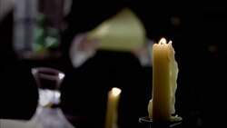 Candles burn on a table as Nostradamus reads a parchment by a window. Stock Footage