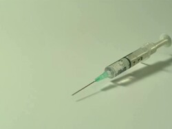 High speed Syringe falls on to surface, white background, high angle Stock Footage