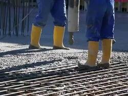 CU Workers Directing Concrete Onto The Construction Site Stock Footage