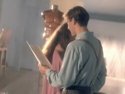 man reads romantic poem to woman inside urban loft apartment decorated with art pieces / Los Angeles, California, USA  Stock Footage