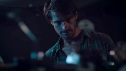 Man in motorcycle workshop looking at his bike Stock Footage