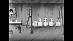 Rooster pulls out perch from under ducks sitting in chicken coop to wake them up; yells at them in German to get them marching like nazi soldiers Stock Footage