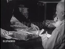 1940: VATICAN CITY: APOSTOLIC LIBRARY: ARCHIVAL RESTORATION: Archivist sitting at desk w/ pages hanging above, Archivists looking at worm-eaten bound manuscript to be restored. Instructional Video