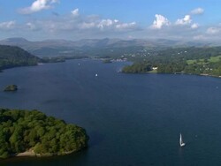 Aerial view over Windermere in the Lake District / yachts sailing on lake / fells in background / Cumbria, England Stock Footage
