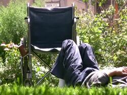 Wheelchair Man resting in Park as World Passes By Stock Footage