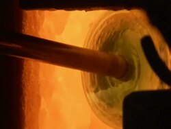 Glass blowing: half made glass vase being heated in furnace, Egypt (sound available) Stock Footage