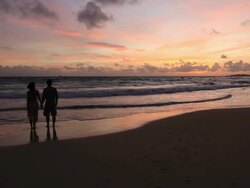 Good Looking Young Couple walking by the Sea at Sunset Stock Footage