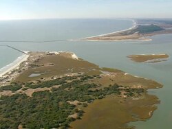WS AERIAL View of ocean and Estuary with town at State border (inlet) / North Carolina, United States Stock Footage