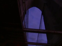 The cables of a suspension bridge line a cloudy night sky. Stock Footage