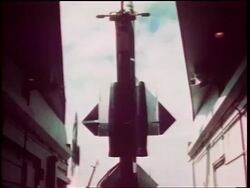 1960s small missile blasting off next to large missile on launch pad / Cold War / documentary Stock Footage
