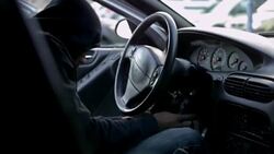 Thief hotwiring a car and stealing it Stock Footage