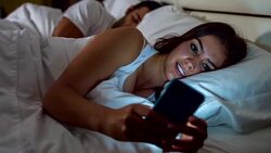 Woman texting in bed Stock Footage