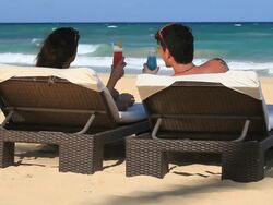 Good Looking Young Couple relax by the sea with cocktails Stock Footage