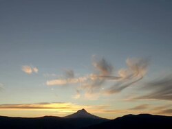 Mount Hood silhouetted against golden sunset and clouds Stock Footage