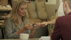 Buying Coffee Using a Mobile Phone and Credit Card Stock Footage