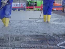 Workers Directing Concrete Onto The Construction Site TL Stock Footage