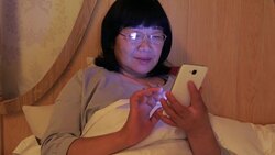 Woman using mobile phone in bedroom Stock Footage