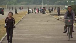 Crowds and trams in centre of Pyongyang News Clip