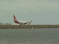 Aircraft taxiing on reclaimed land, Sydney Aiport, Australia Stock Footage