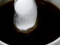 CU SLO MO Sugar falling into bowl of coffee / Vieux Pont, Normandy, France  Stock Footage