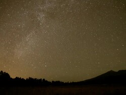 WS T/L Milky way moving across sky over icy peaks  / Flagstaff, Arizona, United States Stock Footage