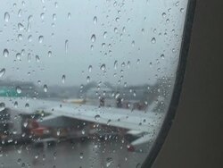 Drops of rain from the airplane window before take off Stock Footage