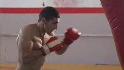 Boxer training in gym with punching bag Stock Footage