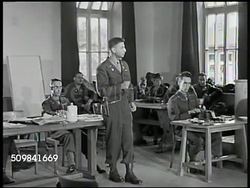 1945: MILITARY TRIBUNAL: PROSECUTION SUMMARY: MS German Nazi Franz Strasser sitting at table. WS Prosecutor Victor Miles summing up testimonies of crime, PAN (R) U.S. Military Commission listening. MS Strasser sitting. MS Commission members sitting. Instructional Video