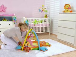 HD CRANE: Putting Baby On A Playmate Stock Footage