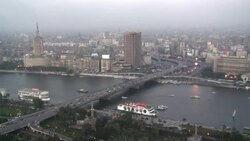 Heavy traffic travels on a bridge over the Nile River in Cairo. Stock Footage