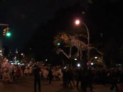 A large skeleton puppet makes its way down the parade route Stock Footage