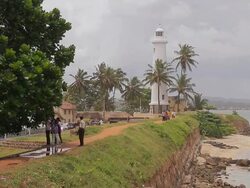 MS View of Light house and tourist on Galle Fort AUDIO / Galle, Southern Province, Sri Lanka Stock Footage