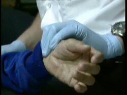 CU Paramedic checking pulse and blood pressure Stock Footage